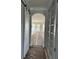 Hallway with sliding barn door and built-in shelving, looking to living area with natural light at 4209 Legacy Ln # 31, Acworth, GA 30101