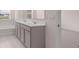 Bathroom features a double sink vanity, tub, and view of outside at 1119 Blue Juniper Circle, Loganville, GA 30052