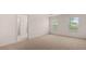 The main bedroom is a spacious room with neutral carpeting and natural light from large windows at 1119 Blue Juniper Circle, Loganville, GA 30052