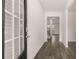 Bright entryway features a stylish front door, hardwood flooring, and an open view to the living space at 1119 Blue Juniper Circle, Loganville, GA 30052