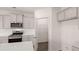 Kitchen is equipped with stainless steel appliances and gray cabinets. The photo also shows a pantry at 1119 Blue Juniper Circle, Loganville, GA 30052