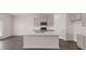The kitchen is equipped with a kitchen island, gray cabinets and stainless steel appliances at 1119 Blue Juniper Circle, Loganville, GA 30052