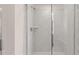 Walk-in shower featuring a tile surround and glass door at 1119 Blue Juniper Circle, Loganville, GA 30052