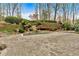 Spacious backyard featuring a gunite pool, a lush waterfall feature and paved patio at 115 Mount Paran Rdg, Atlanta, GA 30327