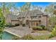 A gunite pool is surrounded by a brick patio and mature landscaping creating the perfect space for relaxation at 115 Mount Paran Rdg, Atlanta, GA 30327