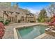 A serene backyard showcases a beautiful gunite pool and an expansive brick patio at 115 Mount Paran Rdg, Atlanta, GA 30327