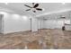 Large finished basement with tile flooring, neutral walls, and ceiling fans offering a versatile living space at 115 Mount Paran Rdg, Atlanta, GA 30327
