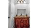 Bathroom features vanity with granite top, tile backsplash, and stylish lighting fixture at 115 Mount Paran Rdg, Atlanta, GA 30327