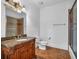 Bathroom featuring ornate vanity with granite countertop, decorative light fixture, and walk-in shower at 115 Mount Paran Rdg, Atlanta, GA 30327