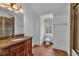 Bathroom with a granite vanity, white toilet, and a brown tiled shower with glass doors at 115 Mount Paran Rdg, Atlanta, GA 30327