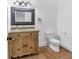 Bathroom featuring tile flooring, a granite-topped vanity, and a framed mirror at 115 Mount Paran Rdg, Atlanta, GA 30327
