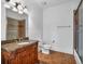 Bathroom featuring ornate vanity with granite countertop, decorative light fixture, and walk-in shower at 115 Mount Paran Rdg, Atlanta, GA 30327