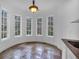 Bright breakfast nook with a curved wall of windows providing natural light and a scenic view of the surrounding trees at 115 Mount Paran Rdg, Atlanta, GA 30327