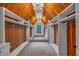 Spacious walk-in closet featuring custom wood paneling, built-in shelving, and a charming chandelier at 115 Mount Paran Rdg, Atlanta, GA 30327