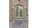 Charming doorway with stone surround, brick walls, and lanterns for warm welcome at 115 Mount Paran Rdg, Atlanta, GA 30327
