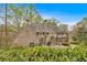 Lovely brick home featuring a manicured lawn and abundant greenery creating a beautiful backyard space at 115 Mount Paran Rdg, Atlanta, GA 30327