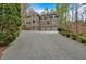 Home exterior with three-car garage and long driveway at 115 Mount Paran Rdg, Atlanta, GA 30327