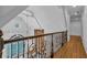 Upstairs hallway featuring hardwood floors, white walls, and wrought iron stair railing at 115 Mount Paran Rdg, Atlanta, GA 30327