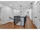 Upstairs hallway with hardwood floors, white walls, and an elegant black iron railing at 115 Mount Paran Rdg, Atlanta, GA 30327