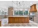Gourmet kitchen with a center island, custom range hood, and luxury stainless steel appliances at 115 Mount Paran Rdg, Atlanta, GA 30327