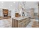 Bright kitchen with a large island, custom cabinets, stone countertops, pendant lighting and an adjacent living area with a fireplace at 115 Mount Paran Rdg, Atlanta, GA 30327
