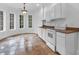 Bright kitchen featuring white cabinetry, stone countertops, tile flooring, and large windows at 115 Mount Paran Rdg, Atlanta, GA 30327