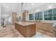 Spacious kitchen with custom cabinets, stone countertops, pendant lighting and large windows overlooking backyard at 115 Mount Paran Rdg, Atlanta, GA 30327