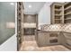 Well-appointed laundry room features custom cabinetry, sink, decorative backsplash and modern fixtures at 115 Mount Paran Rdg, Atlanta, GA 30327