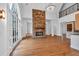 Bright living room with stone fireplace, high ceilings, hardwood floors, and large arched windows at 115 Mount Paran Rdg, Atlanta, GA 30327