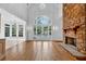 Bright living room with stone fireplace, high ceilings, hardwood floors, and large arched windows at 115 Mount Paran Rdg, Atlanta, GA 30327