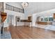 Open-concept living room with hardwood floors connecting to kitchen and featuring a stone fireplace at 115 Mount Paran Rdg, Atlanta, GA 30327