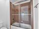 Modern bathroom with a brown tiled walk in shower and glass sliding doors at 115 Mount Paran Rdg, Atlanta, GA 30327