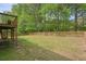 Spacious backyard with a well-maintained lawn, wood perimeter fence and mature trees at 3130 Crestmont Nw Way, Kennesaw, GA 30152