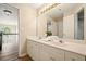 Bathroom vanity with double sinks, a large mirror, and access to other areas of the home at 3130 Crestmont Nw Way, Kennesaw, GA 30152