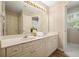 Bathroom with a large mirror above a double vanity and modern lighting fixtures at 3130 Crestmont Nw Way, Kennesaw, GA 30152