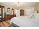 Comfortable bedroom featuring hardwood floors, and an antique-style dresser and wardrobe set at 3130 Crestmont Nw Way, Kennesaw, GA 30152