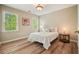 Cozy bedroom features wood-look flooring and two bright windows for natural light at 3130 Crestmont Nw Way, Kennesaw, GA 30152