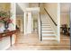 Inviting foyer with wood floors, staircase, neutral walls, and bright lighting at 3130 Crestmont Nw Way, Kennesaw, GA 30152