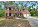 Elegant red brick home boasting classic architectural design, black shutters, and a two-car garage at 3130 Crestmont Nw Way, Kennesaw, GA 30152