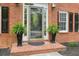 Elegant front door with decorative glass, flanked by potted ferns and black shutters at 3130 Crestmont Nw Way, Kennesaw, GA 30152