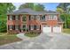 Traditional brick home with a well-manicured lawn, large windows, and an attached garage at 3130 Crestmont Nw Way, Kennesaw, GA 30152