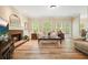 Bright living room with hardwood floors, fireplace, large windows, and comfortable seating at 3130 Crestmont Nw Way, Kennesaw, GA 30152