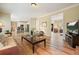 Open-concept living room with wood floors, seamless flow, and a view of the kitchen at 3130 Crestmont Nw Way, Kennesaw, GA 30152