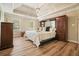 Bright main bedroom with a trey ceiling, wood floors, and a large storage cabinet at 3130 Crestmont Nw Way, Kennesaw, GA 30152