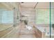 Shower showcasing neutral-toned tiles, a showerhead, and a glass enclosure with a built in bench at 3130 Crestmont Nw Way, Kennesaw, GA 30152