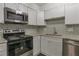 Updated kitchen with stainless steel appliances, granite countertops, and backsplash at 41 Cantey Nw Pl, Atlanta, GA 30327