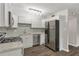 Updated kitchen with stainless steel appliances, granite countertops, and backsplash at 41 Cantey Nw Pl, Atlanta, GA 30327