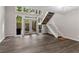Bright living room with hardwood floors, staircase, and a door leading to outdoor space at 41 Cantey Nw Pl, Atlanta, GA 30327