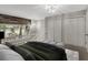 Comfortable main bedroom featuring soft lighting, wood accent, a large window, and ample closet space at 41 Cantey Nw Pl, Atlanta, GA 30327