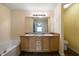 This bathroom has an oak double vanity, a large mirror, and a separate tub and toilet at 5556 Cascade Sw Run, Atlanta, GA 30336